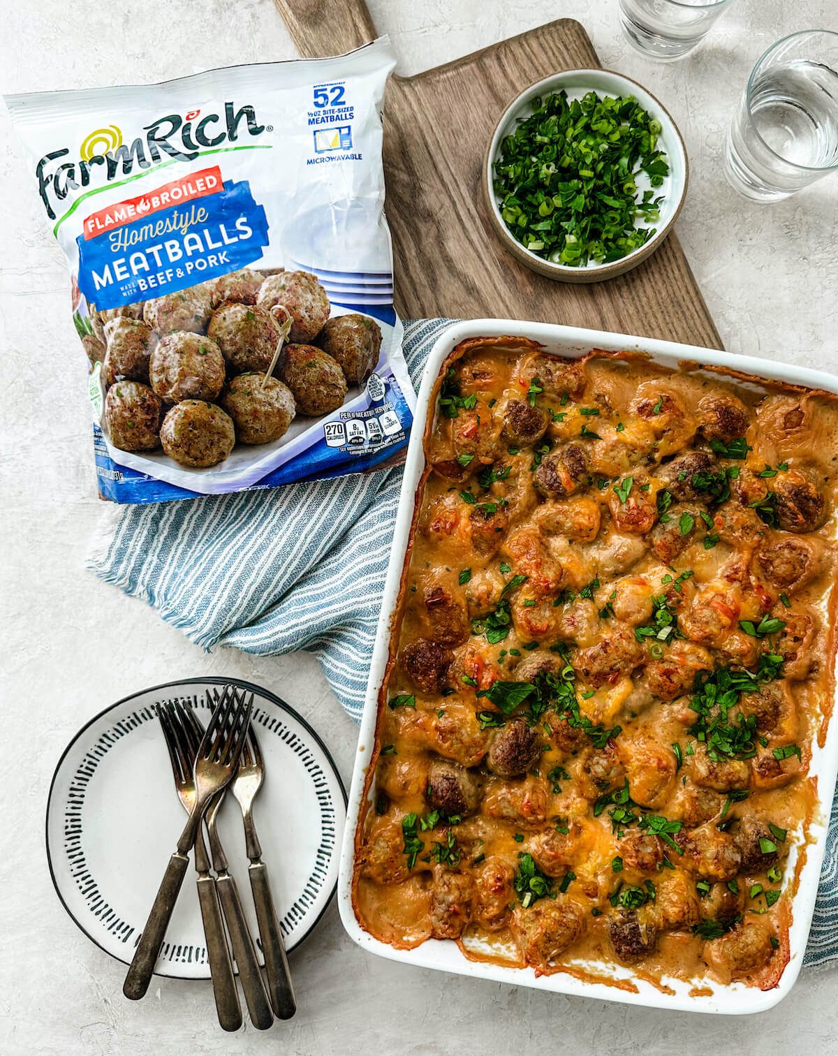 Baking dish of meatball casserole with FarmRich meatballs in package on the side showing product.