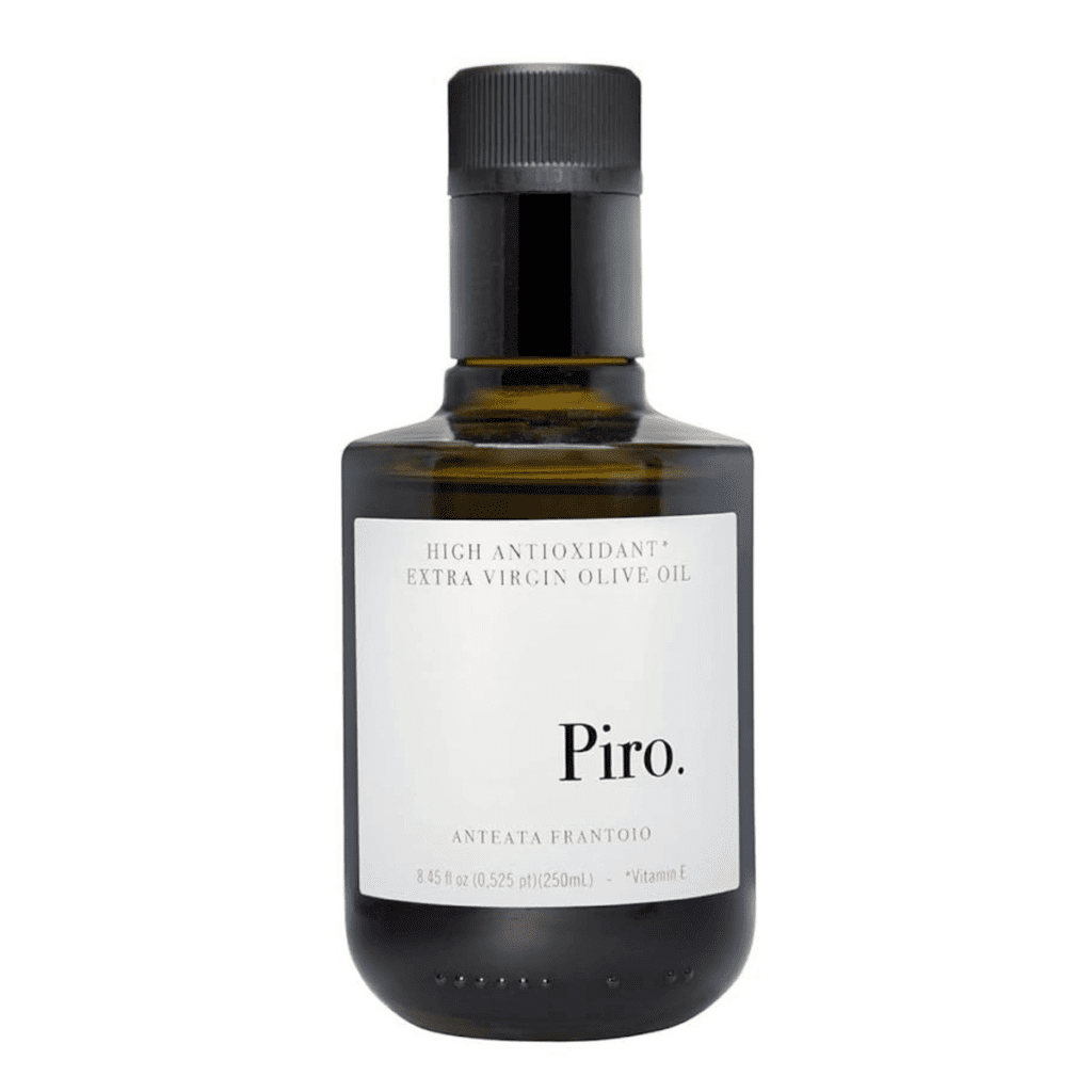 A bottle of Piro olive oil in a dark olive green glass container and a white label.