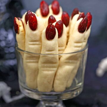 A glass jar filled with witch finger cookies.
