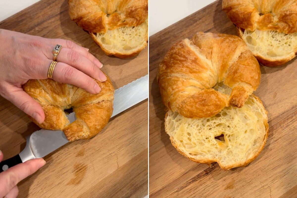 croissant being cut into half horizontally with a serrated knife to make a croissant breakfast sandwich