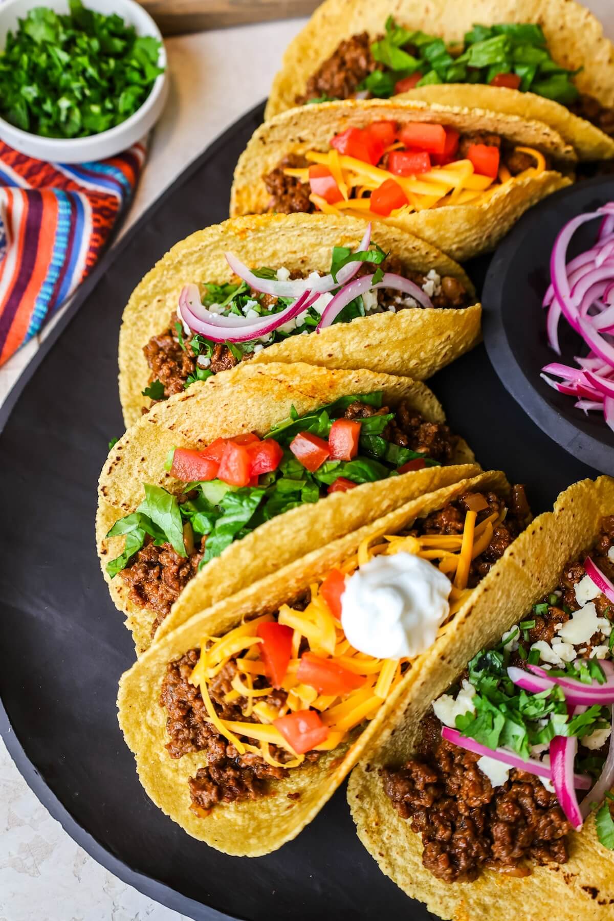 close up of ground beef tacos in corn tortillas.