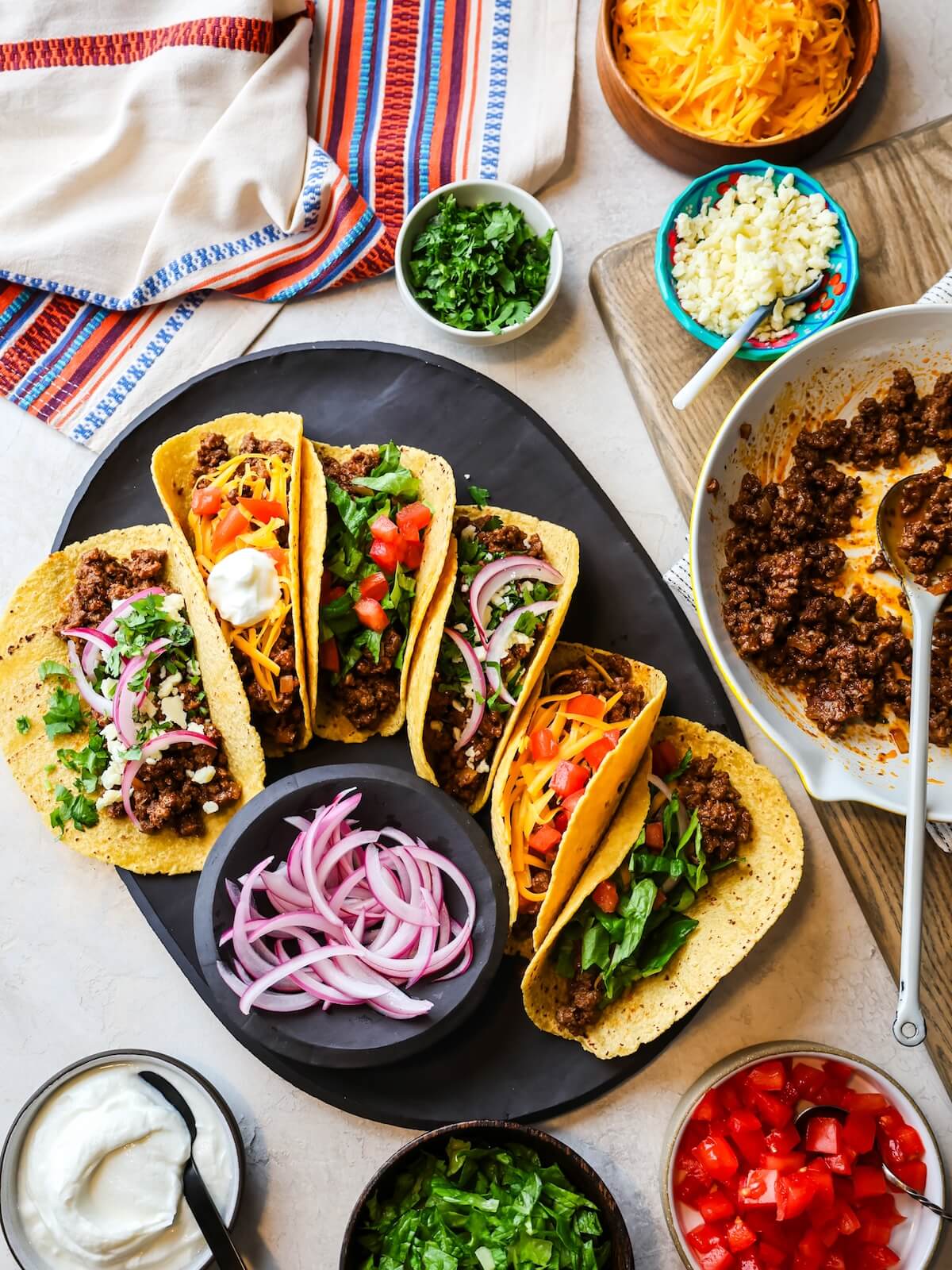 The best ground beef tacos on a platter ready to serve with all the toppings.