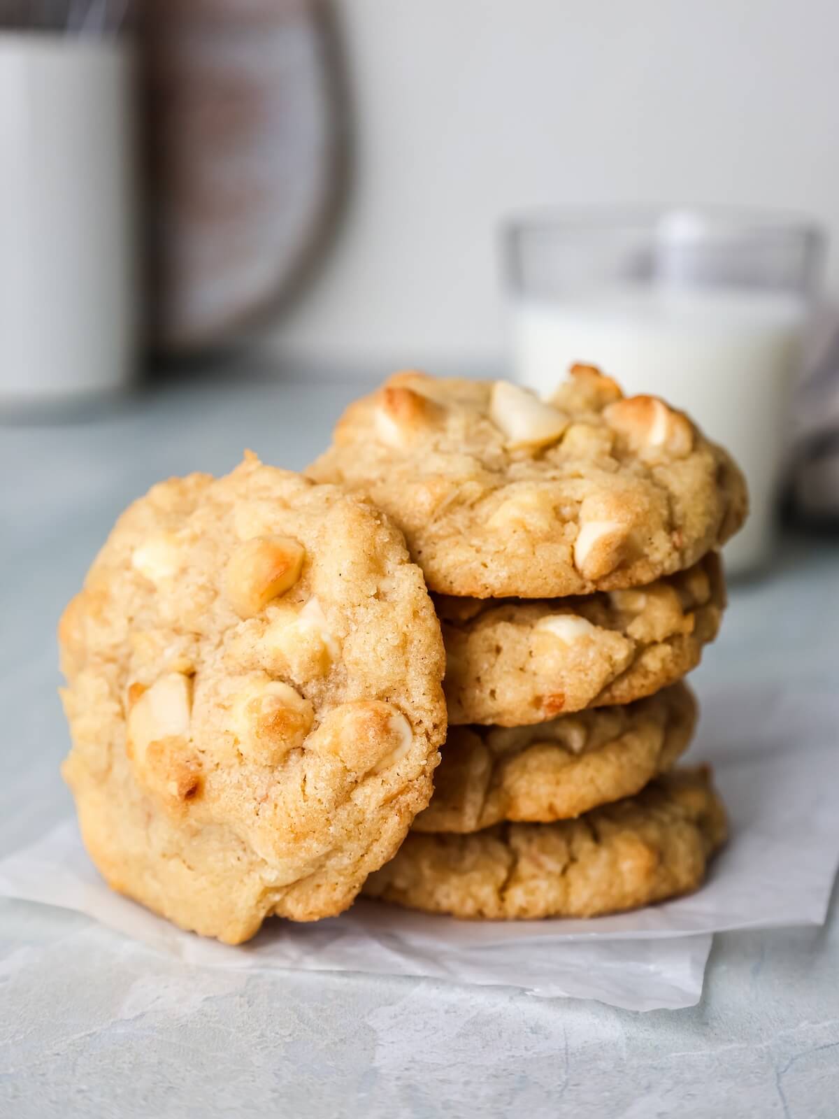 macadamia nut cookies with white chocolate chips and coconut in a stack.