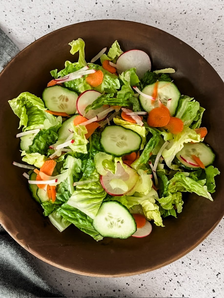 Salad made by slicing vegetables with a mandoline slicer.