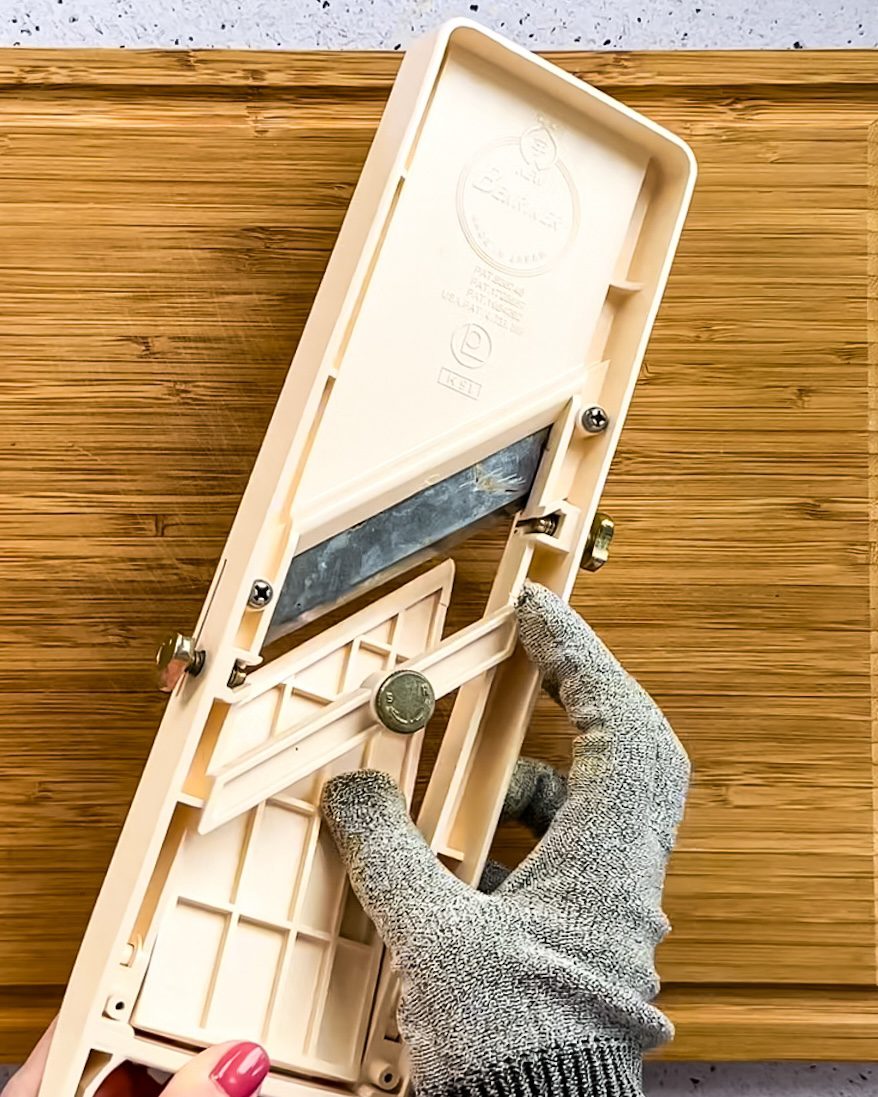 Some mandoline slicers are adjustable with a knob on the back.