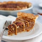 Pecan pie with caramel drizzle on top.