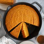 Looking into a skillet with sweet potato cornbread.