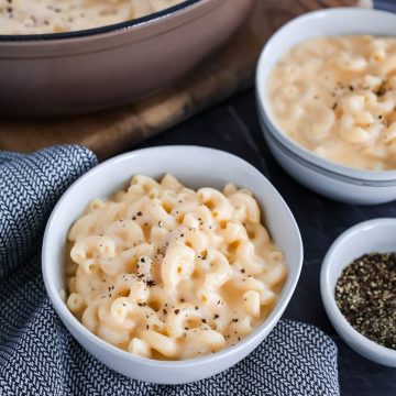 A bowl of 4 cheese mac and cheese with ground pepper on top.