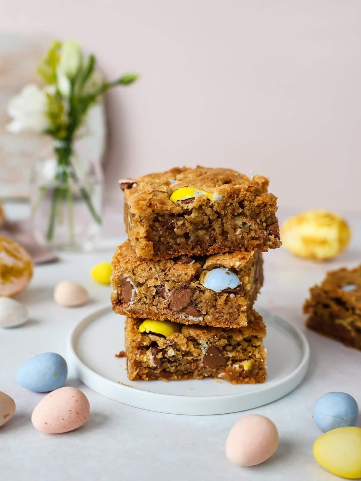 A stack of three baked Easter Blondies on a small white plate.