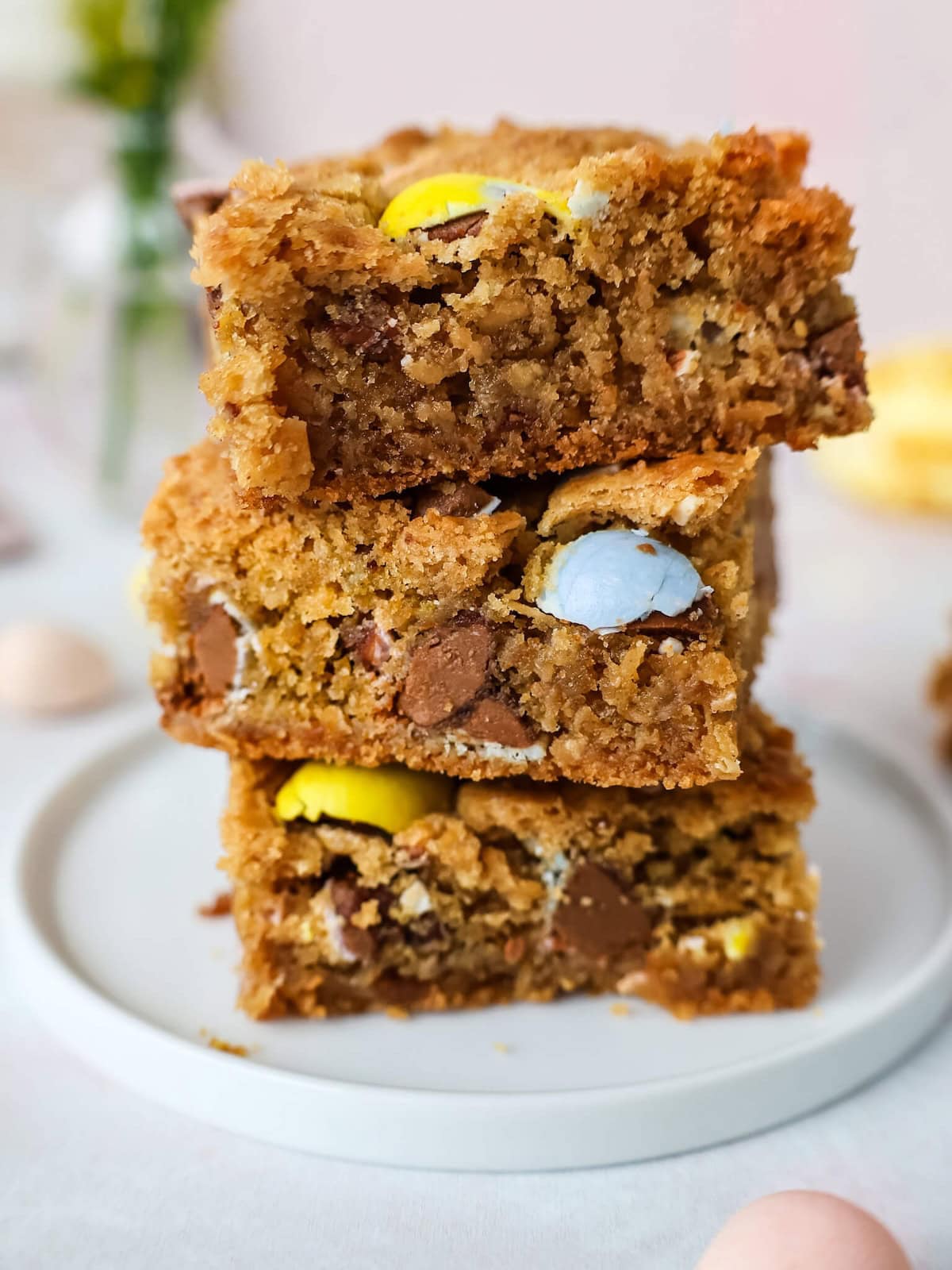 Close up of a stack of three Easter blondies on a small white plate.