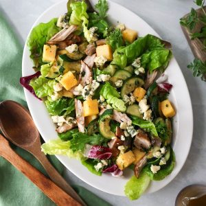 Top view of a polenta zucchini salad in a serving bowl.