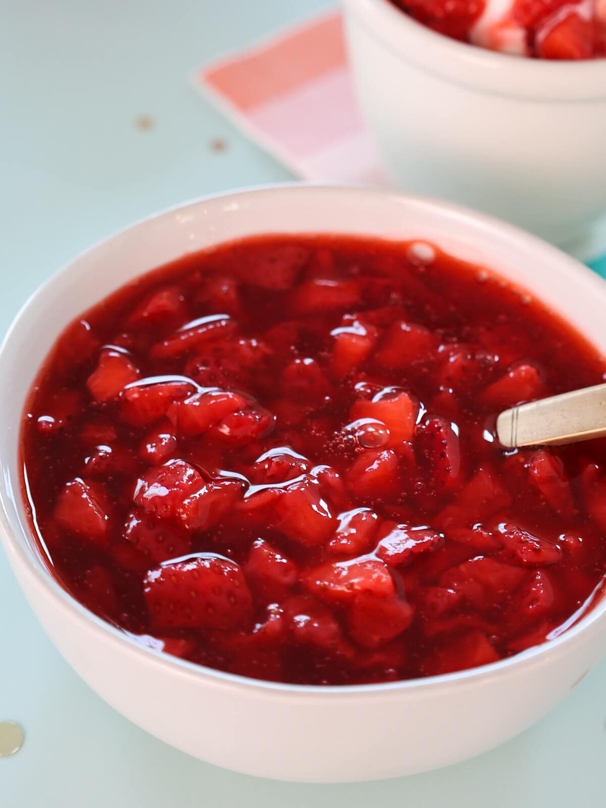 Close up of a bowl of strawberry ice cream sauce.