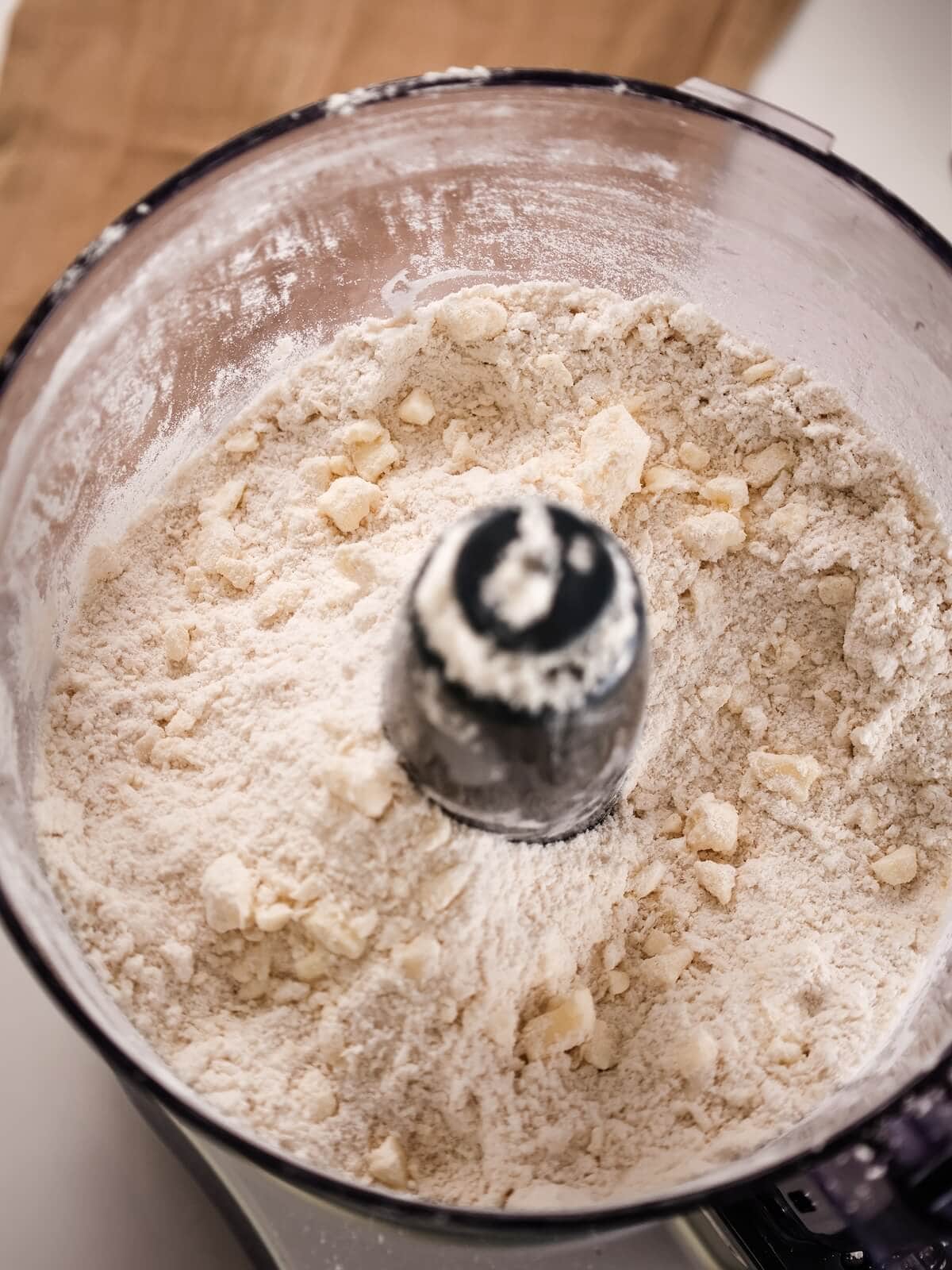 Loosely blended pie crust ingredients in a food processor.