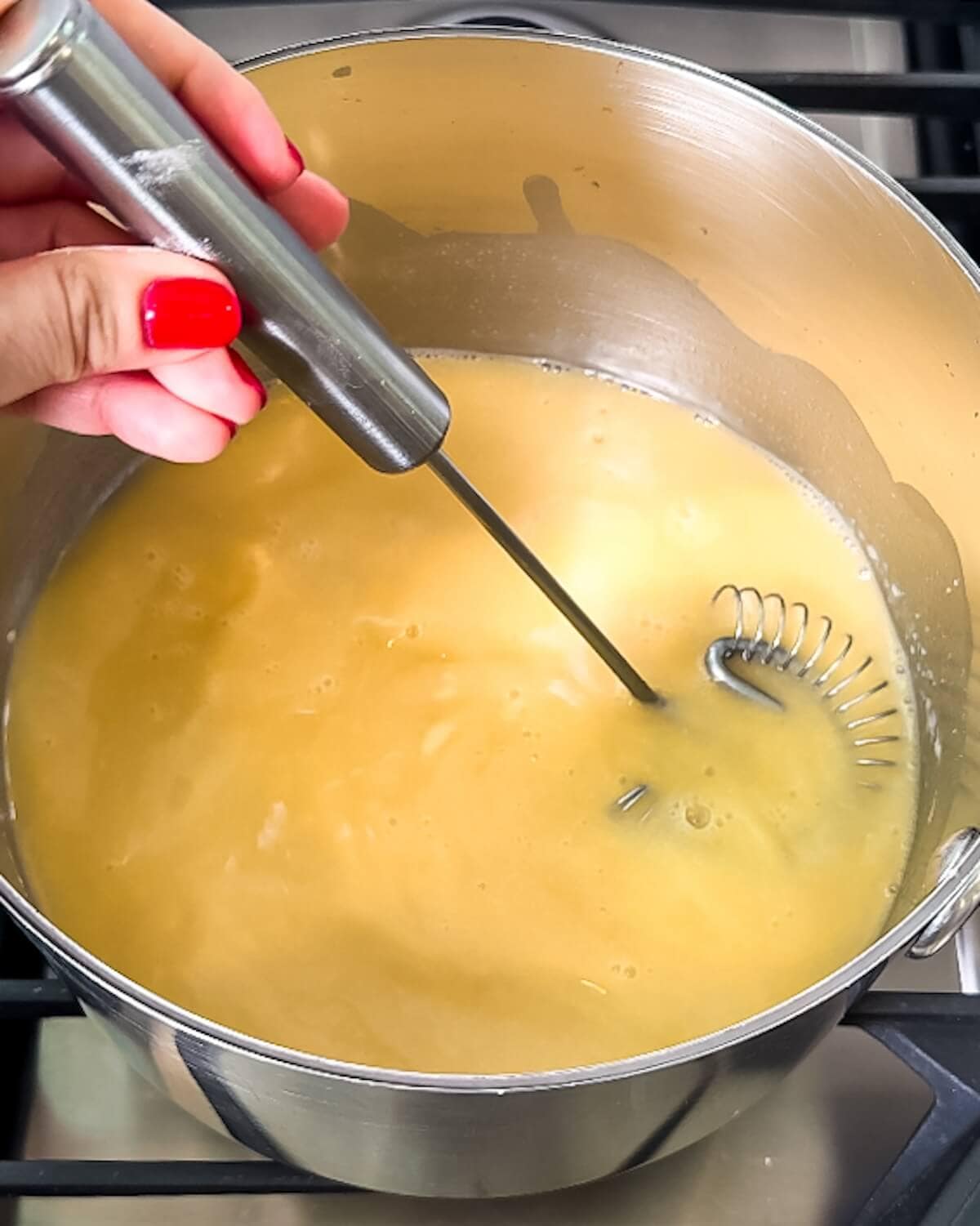Smooth mixture of chicken both, butter, flour, and cornstarch in a saucepan.