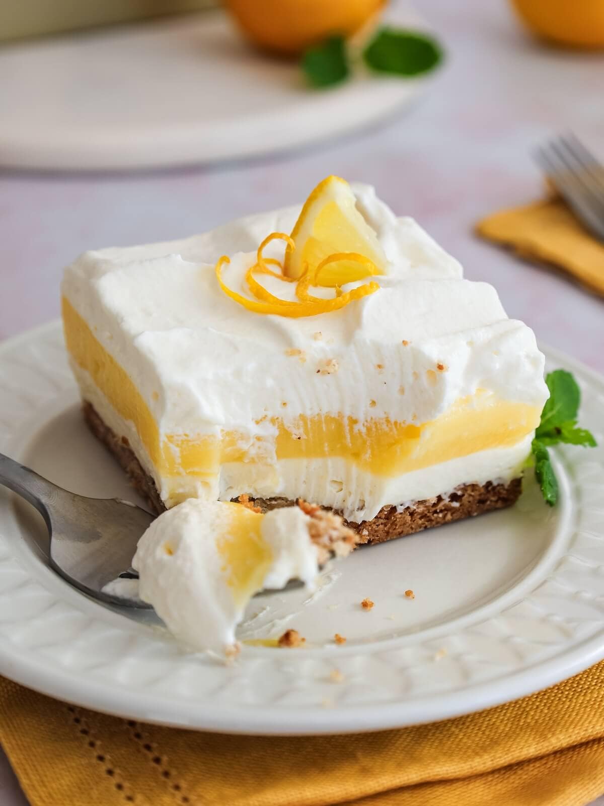 Bite on fork of lemon lush icebox dessert.