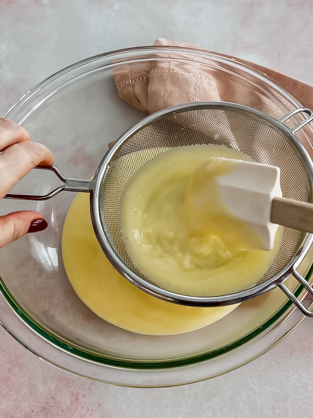 Strain lemon curd through a fine mesh sieve before cooling.