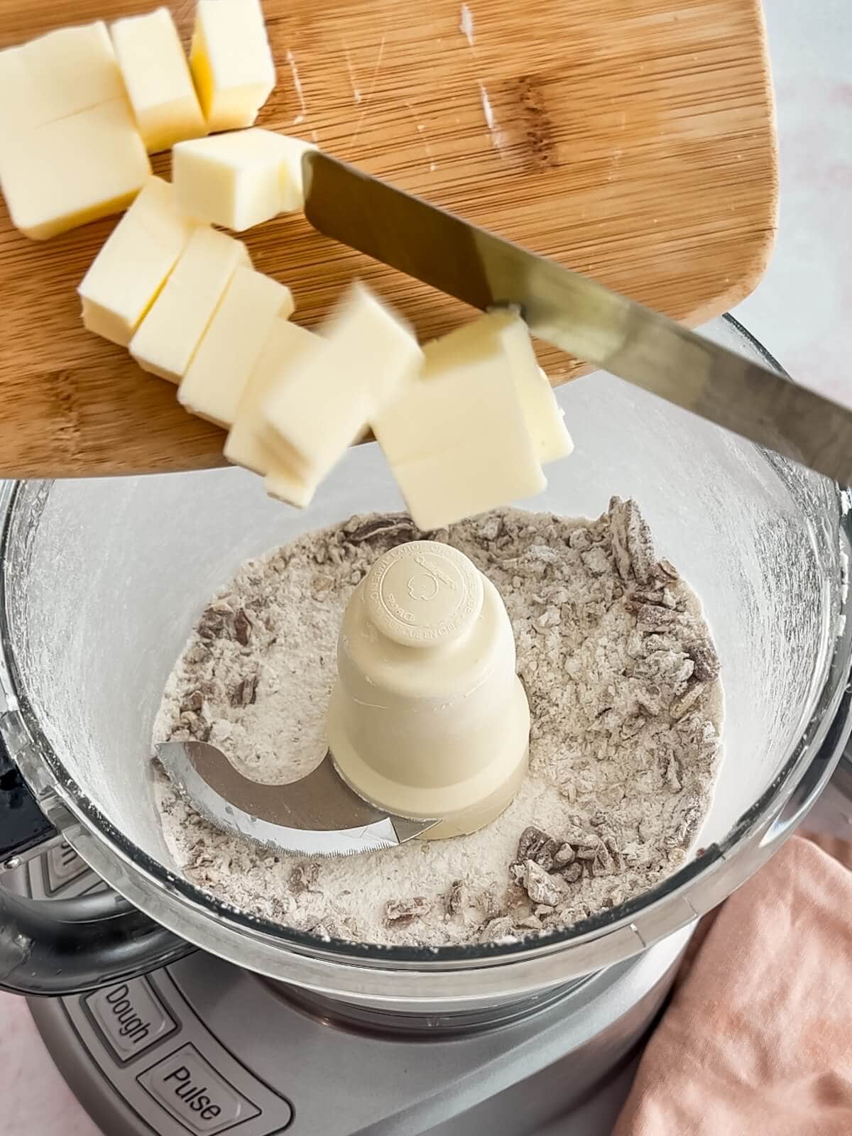 Adding butter to food processor to make crust for lemon lush.