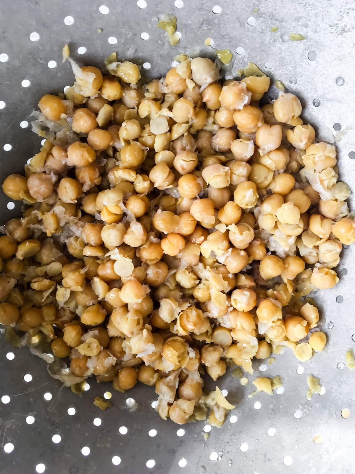 Drain boiled chickpeas in a colander for hummus.
