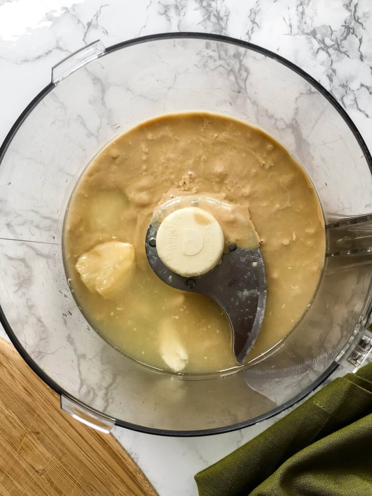 soaking garlic and tahini with lemon juice for hummus.