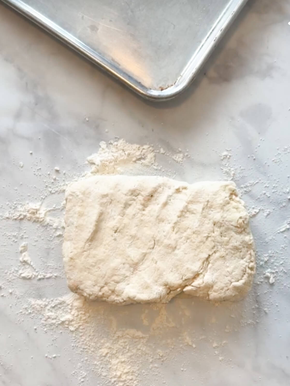 Gathered biscuit dough ready to form into biscuits by hand.