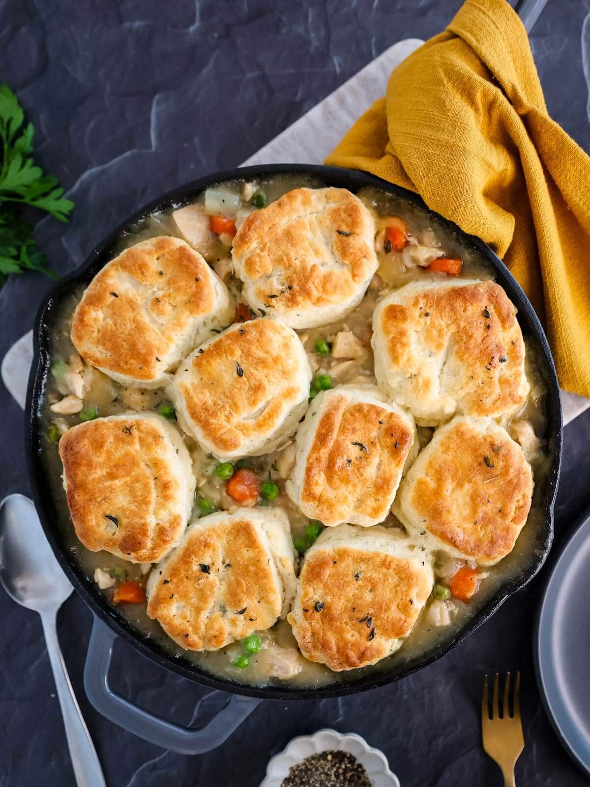 Turkey pie with biscuit top on table ready to eat.