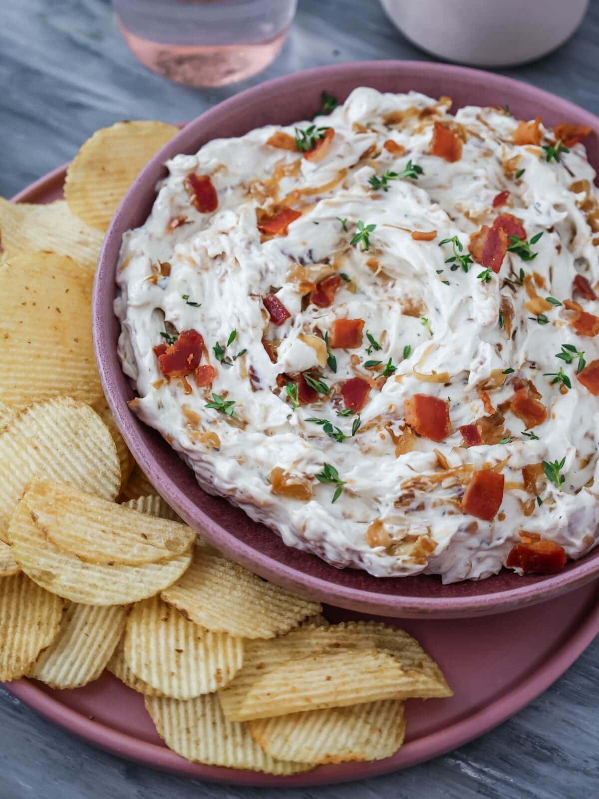 onion bacon dip with potato chips for dipping.