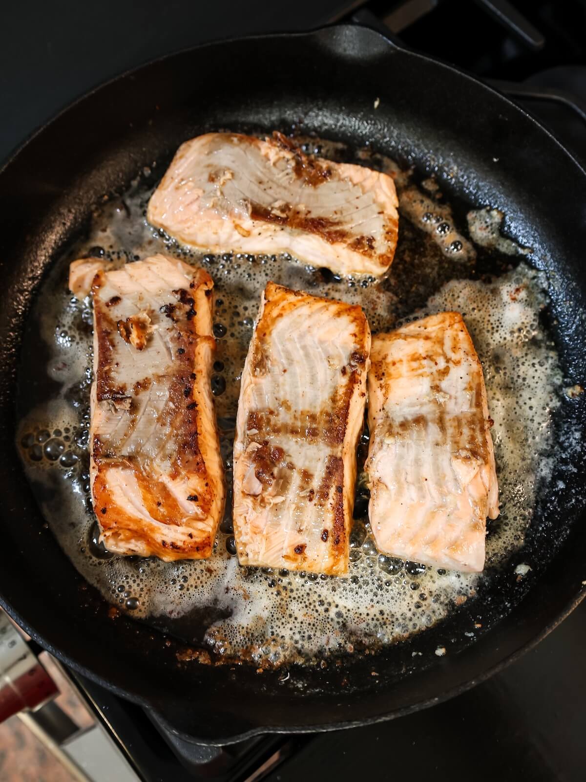 cooked salmon in a cast iron skillet.