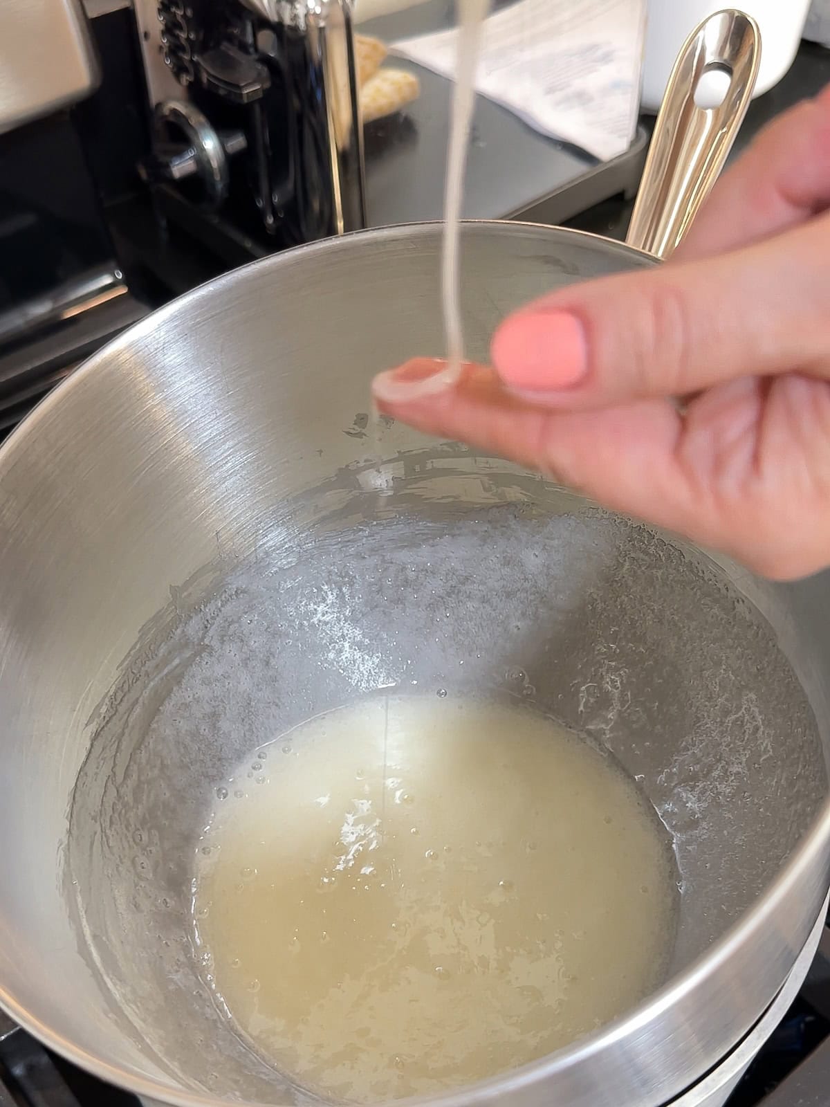 rubbing heated egg whites and sugar between your fingers to see if the sugar is dissolved.