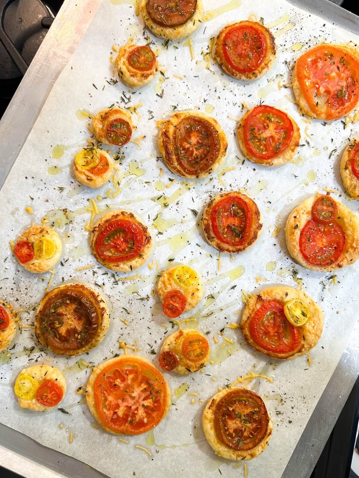baked mini tarts on cookie sheet.