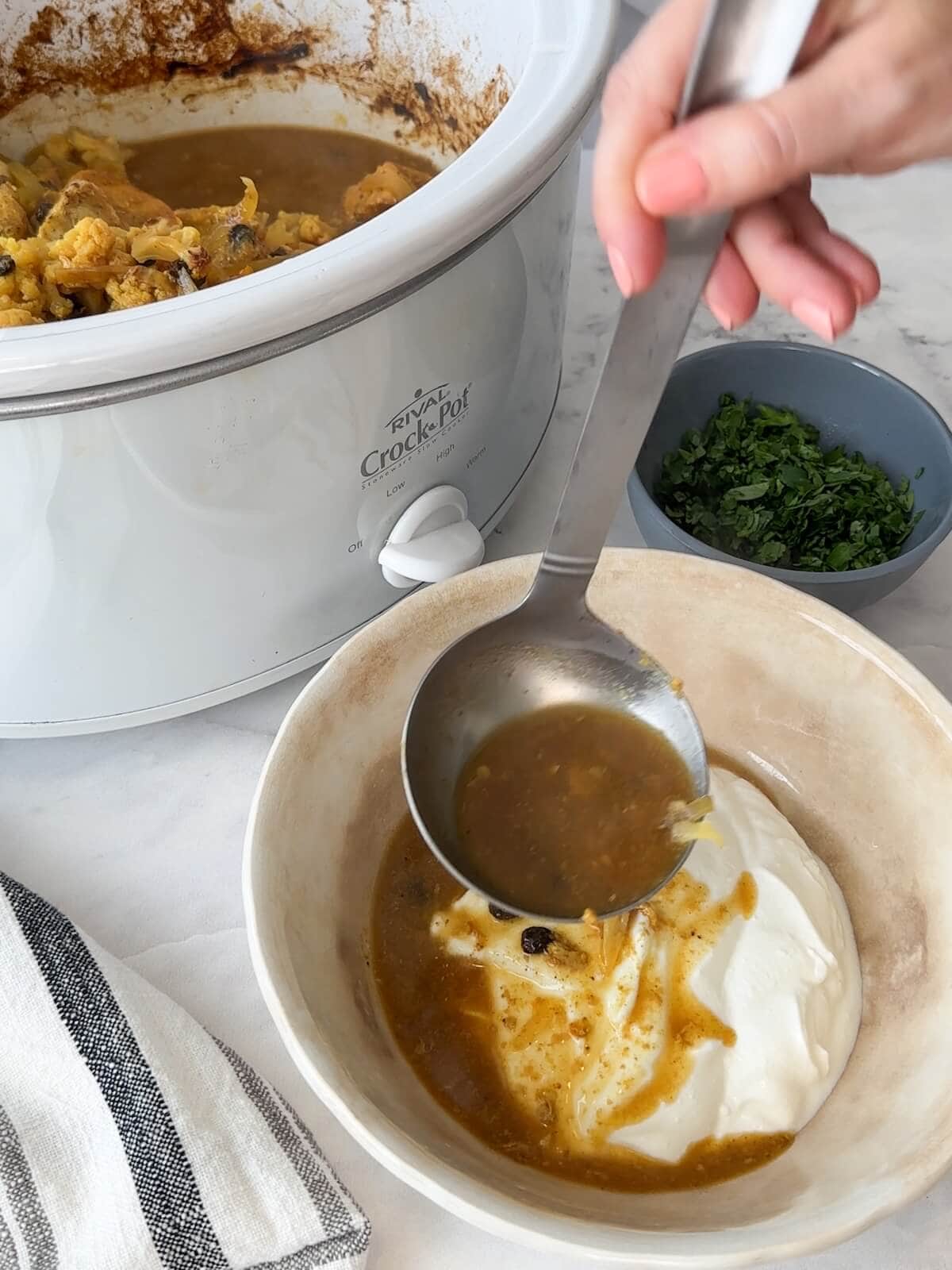 Adding chicken curry liquid to yogurt for final step.