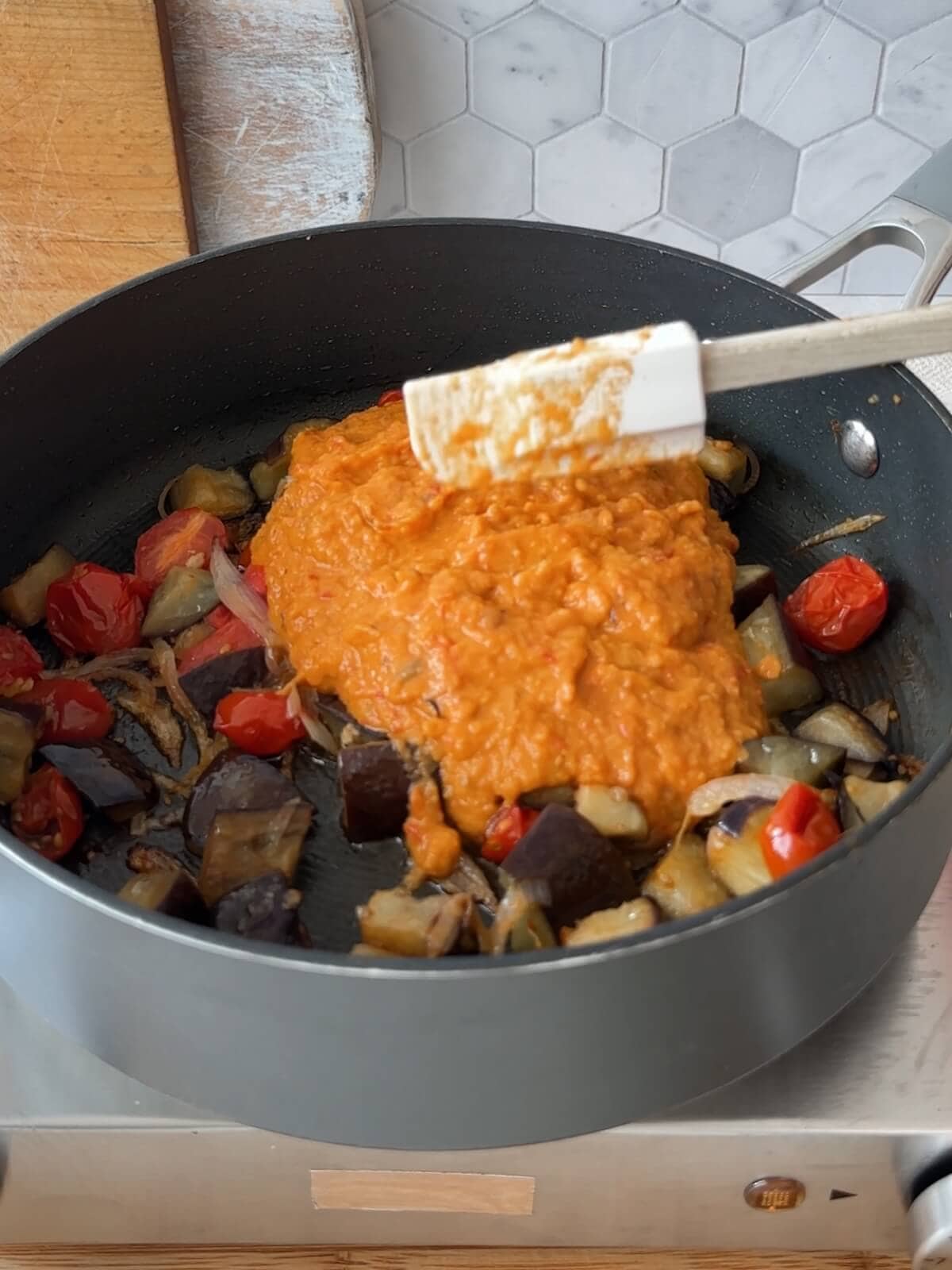 Add the puree back to the skillet to heat with vegetables.