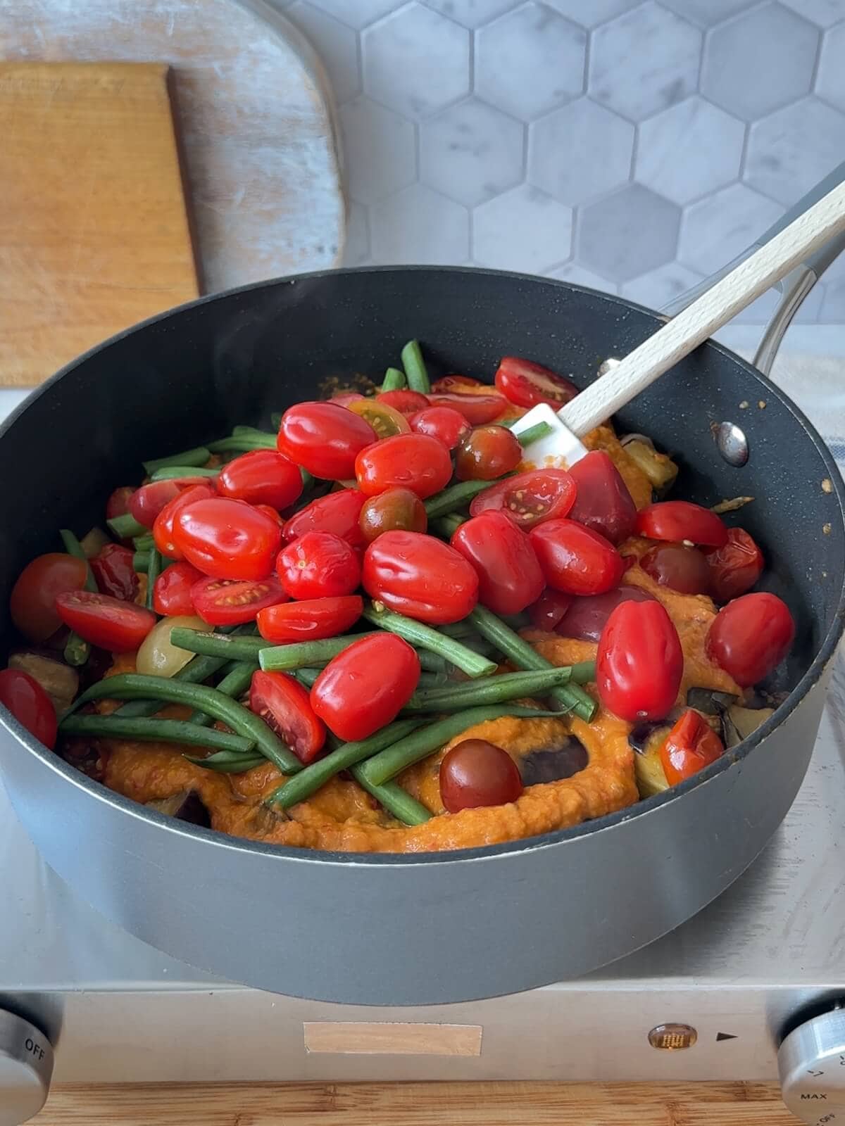 Add remaining fresh beans and tomatoes to the skillet to heat through.