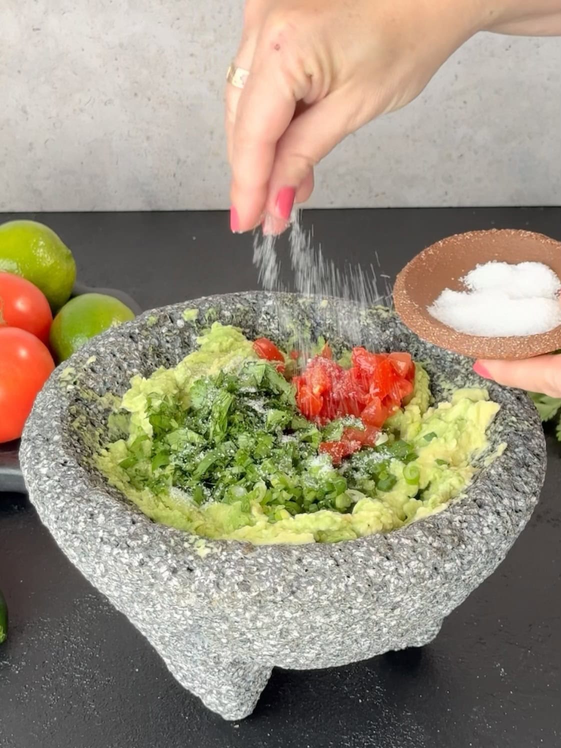 sprinkle salt on homemade guacamole to season.
