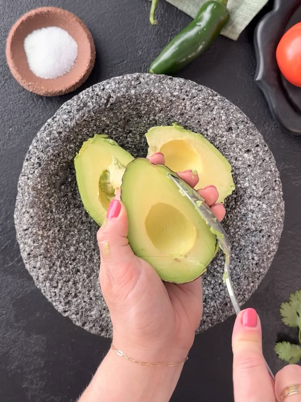scooping avocado from skin for guacamole