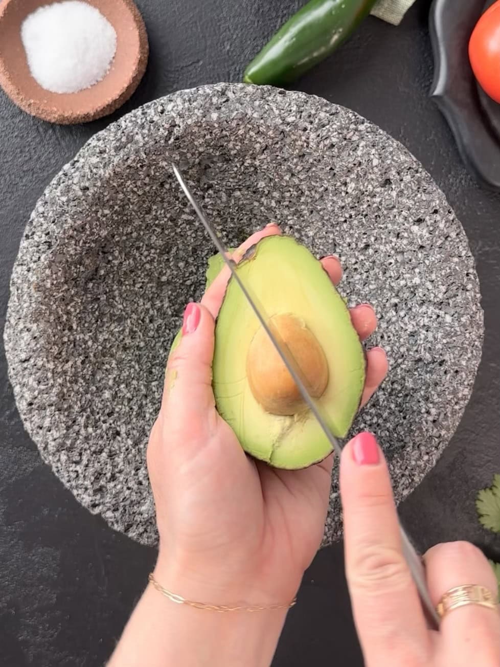 Removing pit from avocado.