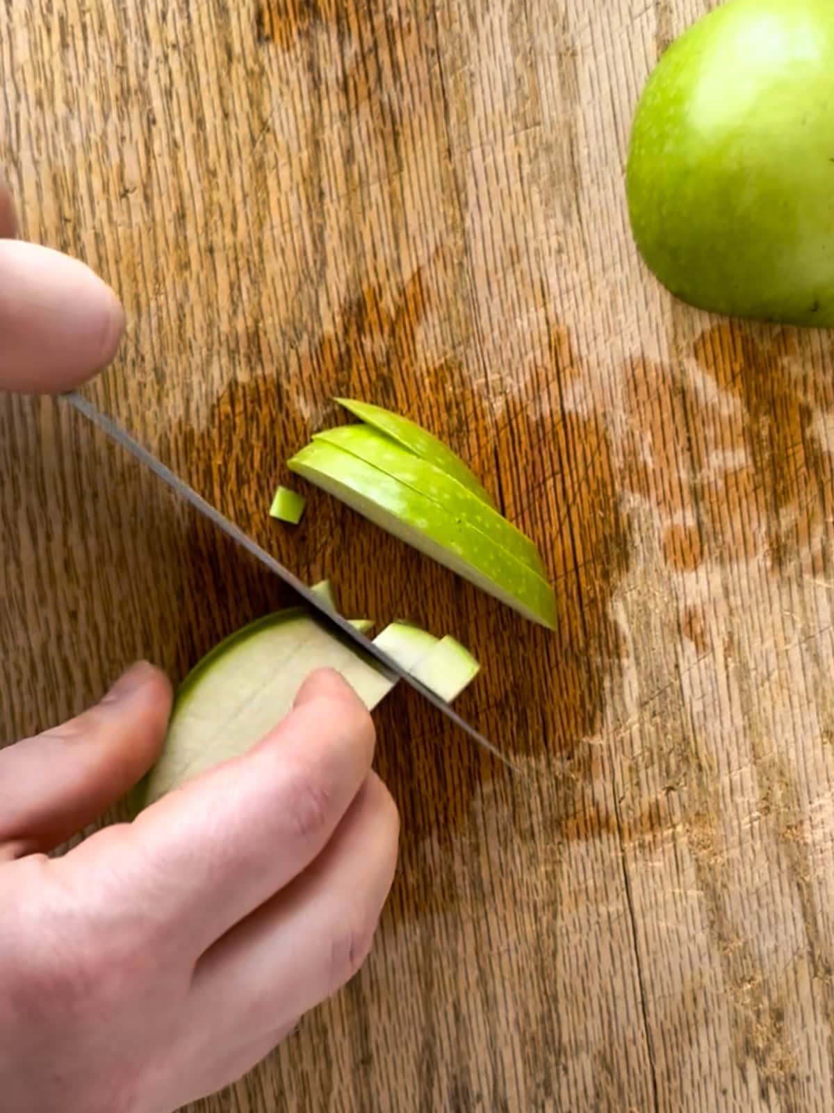 dicing an apple for shredded carrot salad.