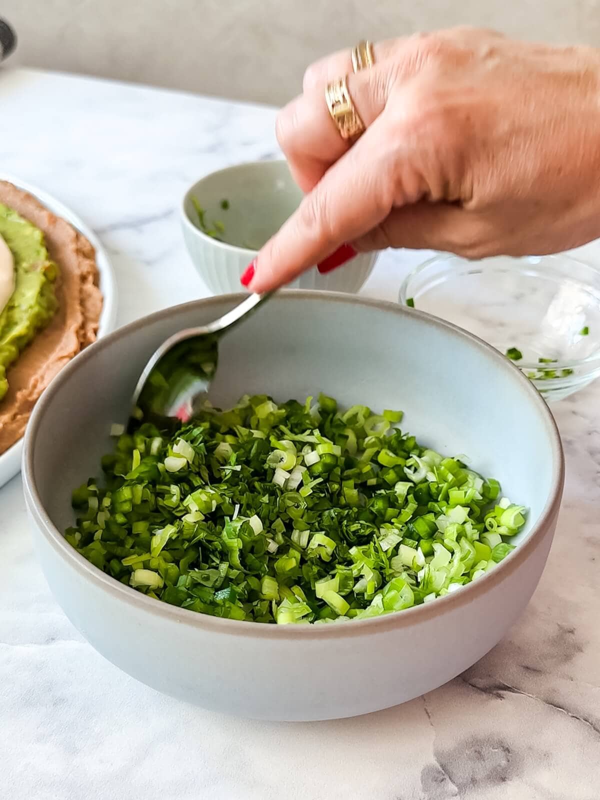 Mix together jalapeno, cilantro, and green onions for 7 layer dip