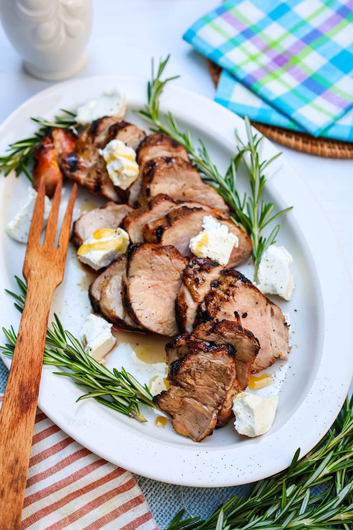 platter of grilled pork tenderloin on an outdoor table.