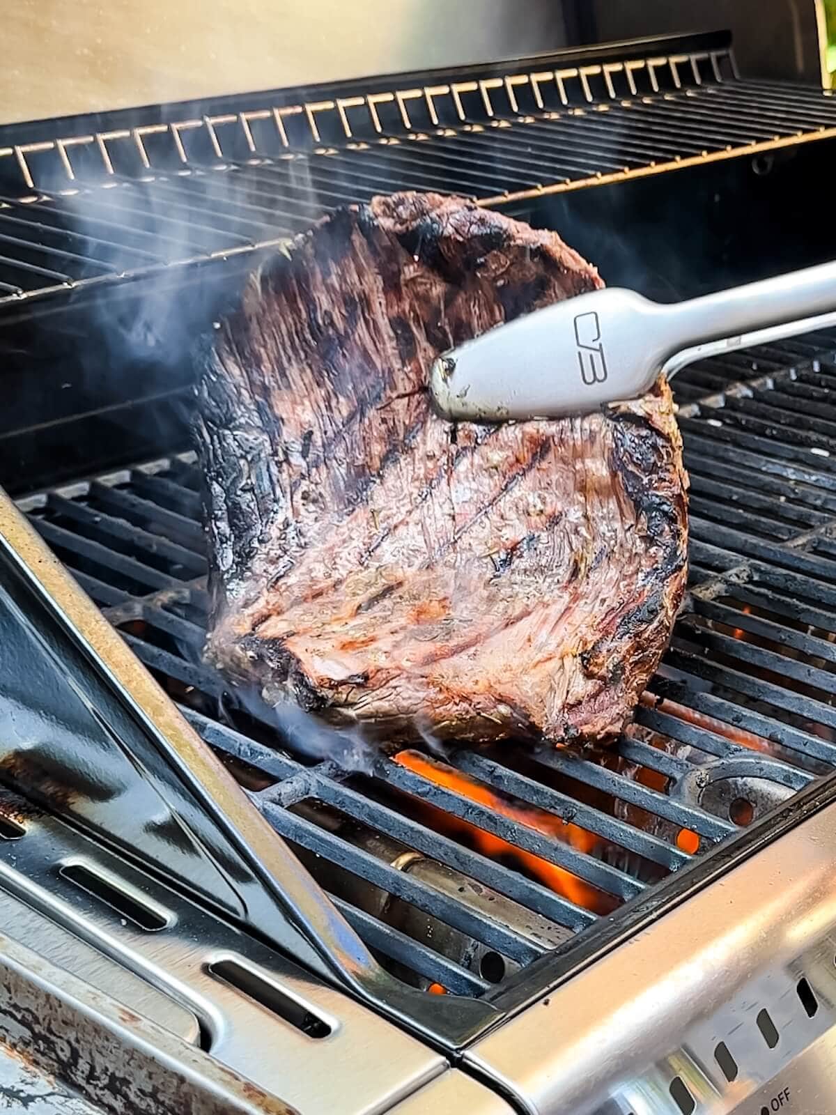 turning flank steak over on the grill after about 5 minutes