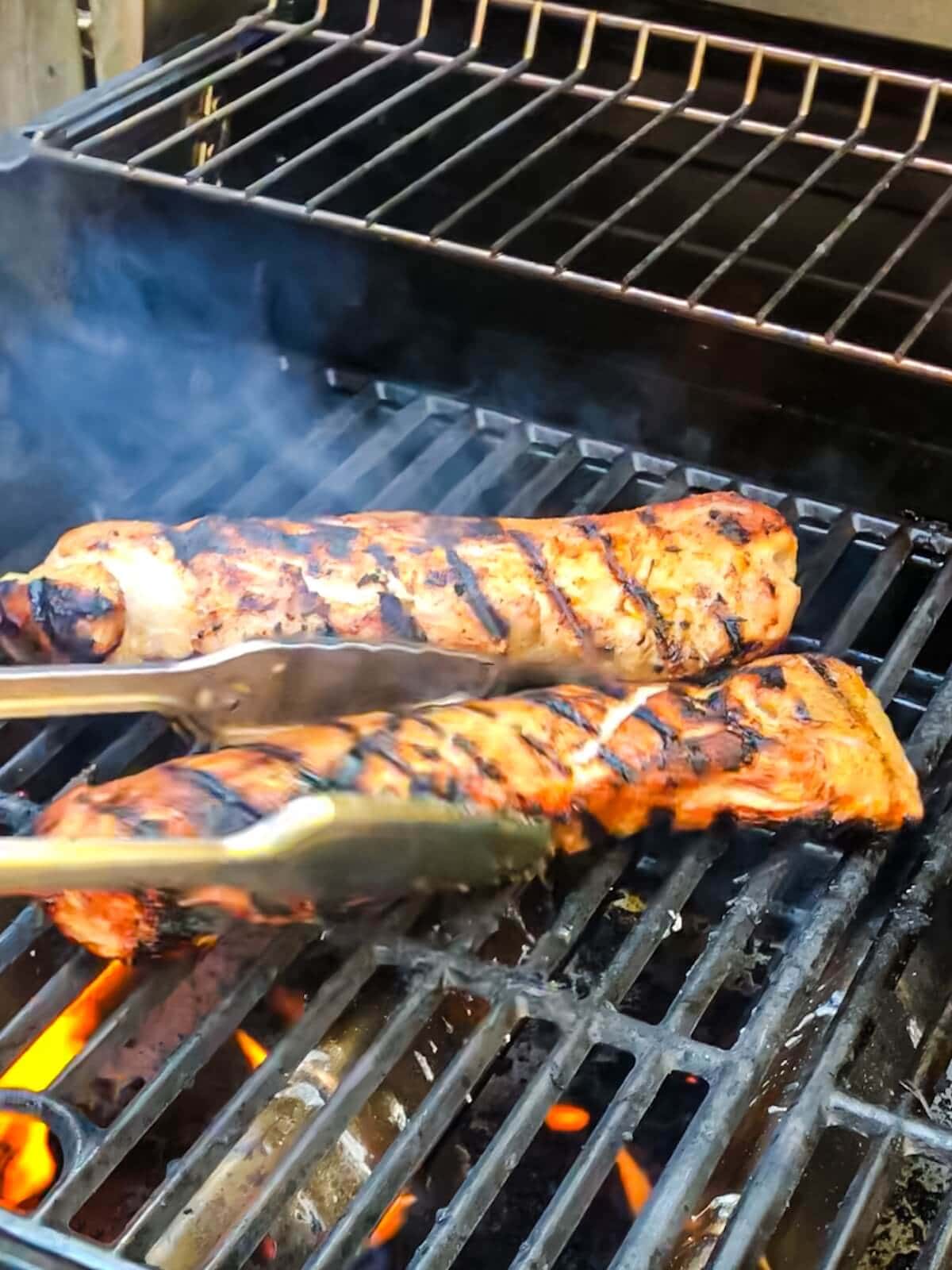 grilling pork tenderloin on an outdoor gas grill.