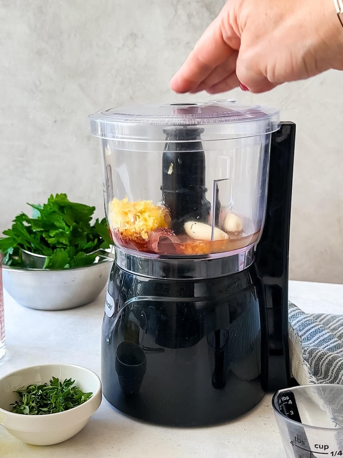 blend zest, garlic, anchovies and liquid in mini food processor before adding herbs for salsa verde