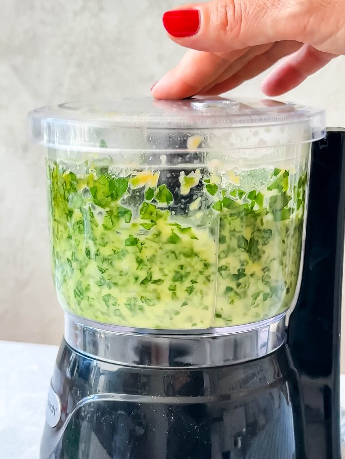 blend herbs and flavors with olive oil in a mini food processor for the salsa verde