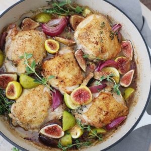 feature image of chicken and figs in a skillet with herbs and red onions