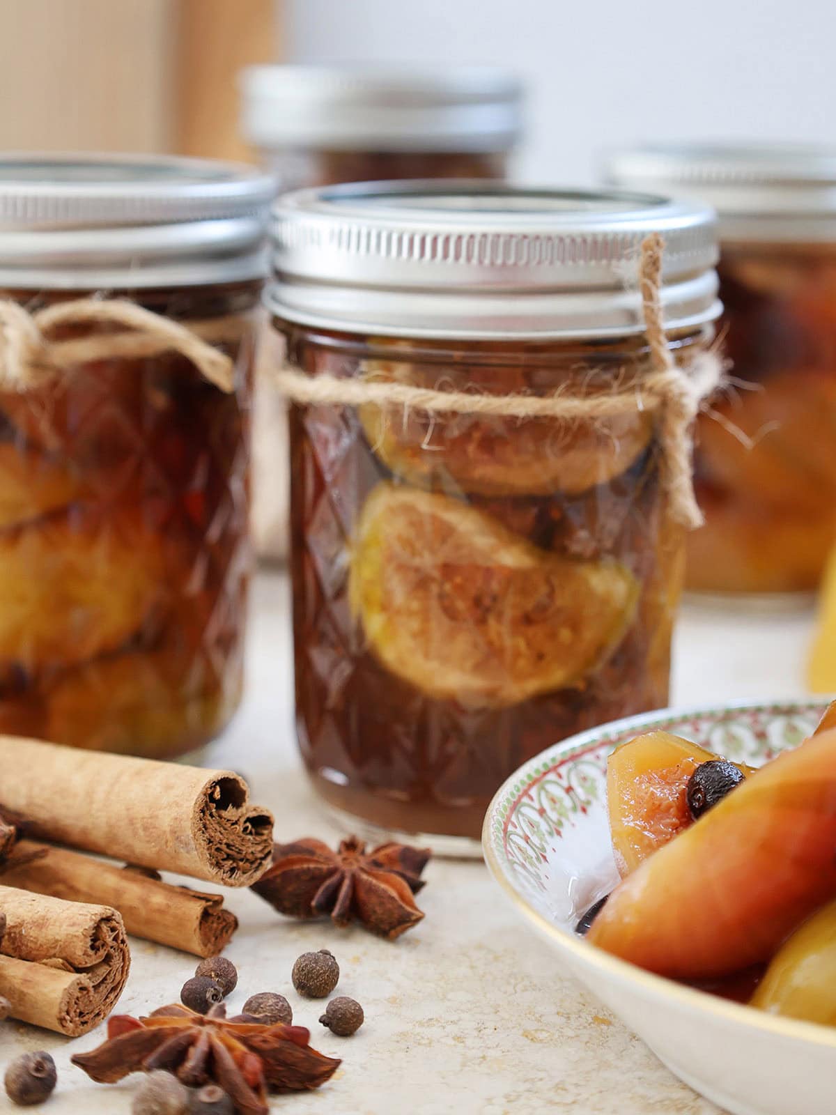 jar of fresh figs preserved in syrup with twine tied around the top