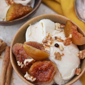 close up feature of ice cream with figs in syrup on top