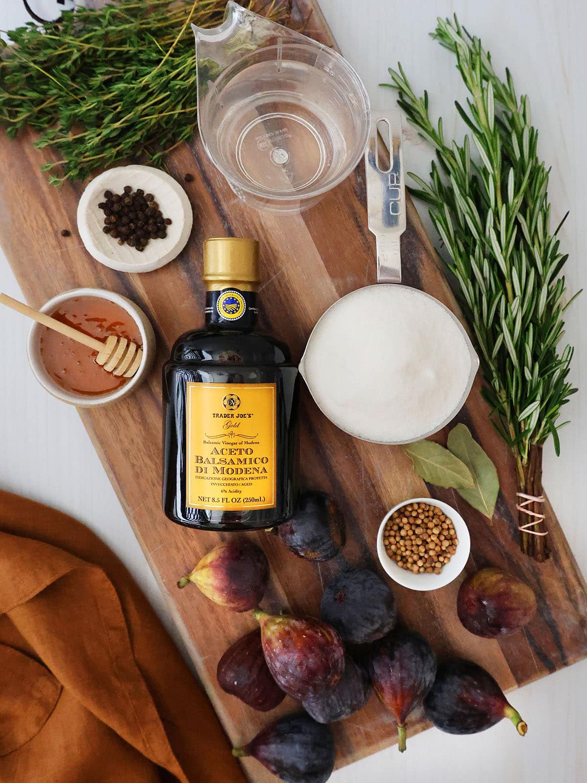 ingredients for preserved balsamic figs including figs, sugar, water, herbs, spices, honey and balsamic vinegar.