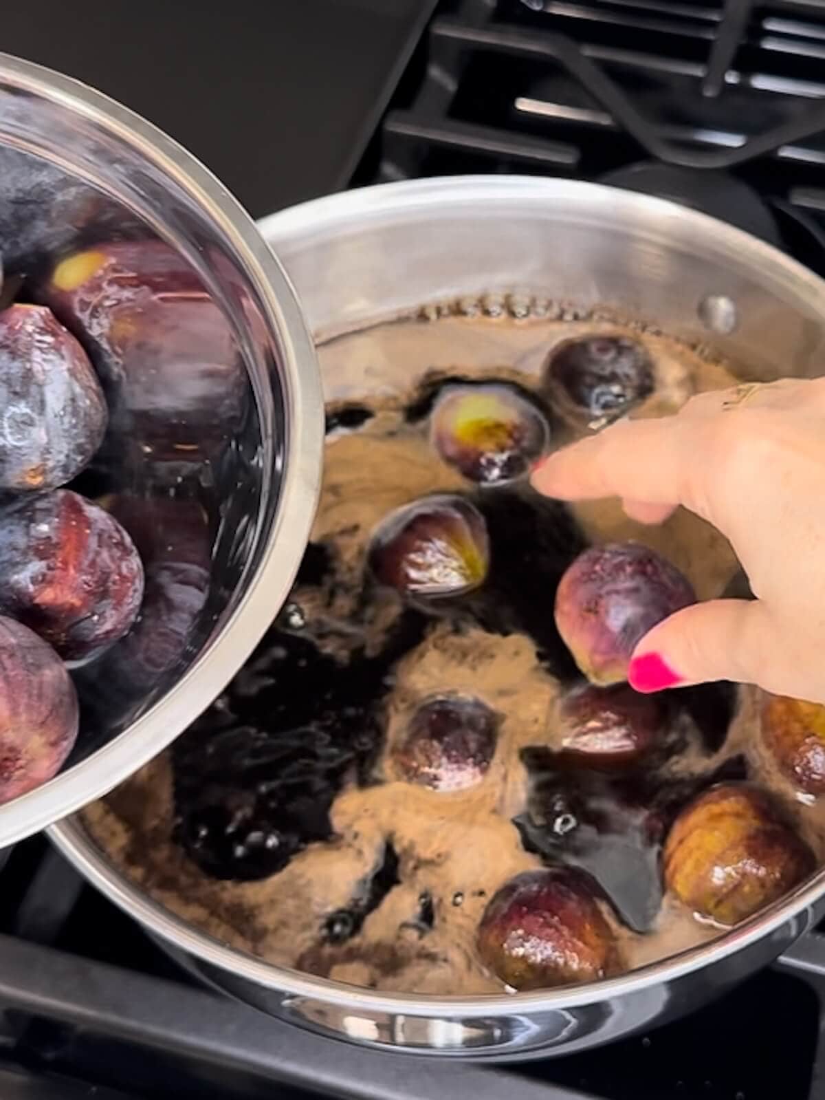 Adding fresh figs to balsamic syrup to cook.
