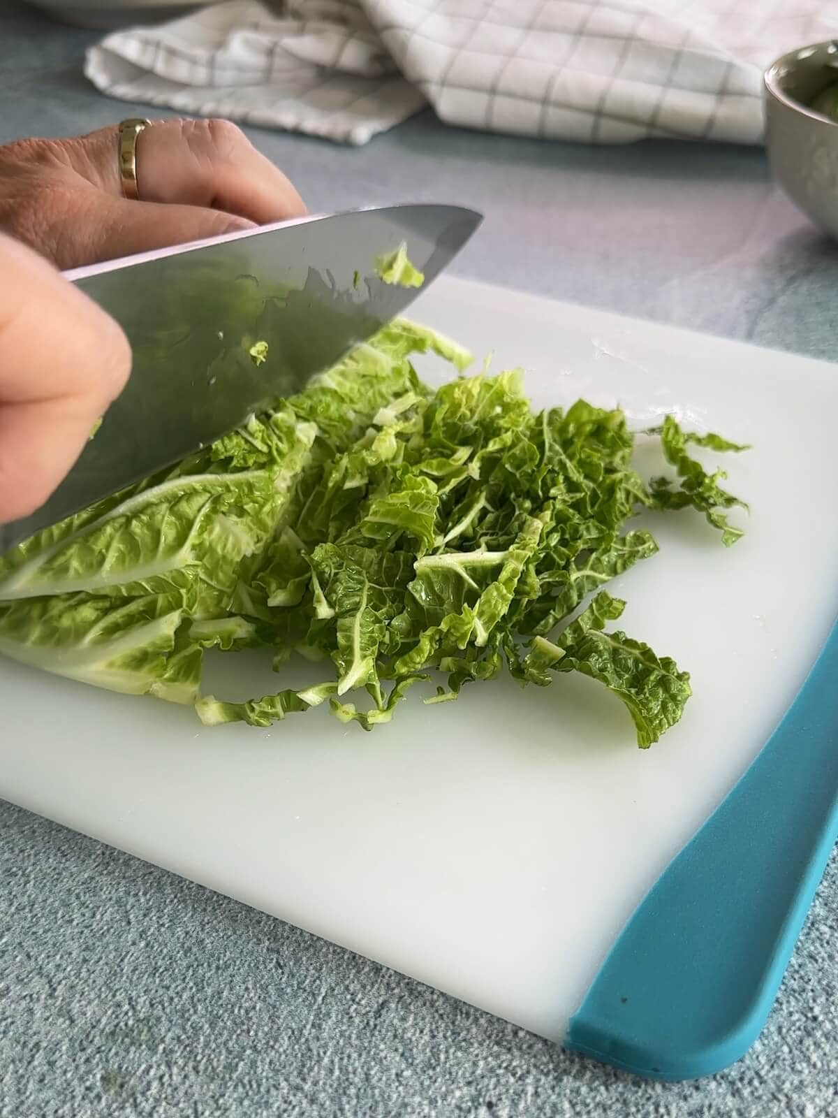 thinly slicing napa cabbage for asian slaw.