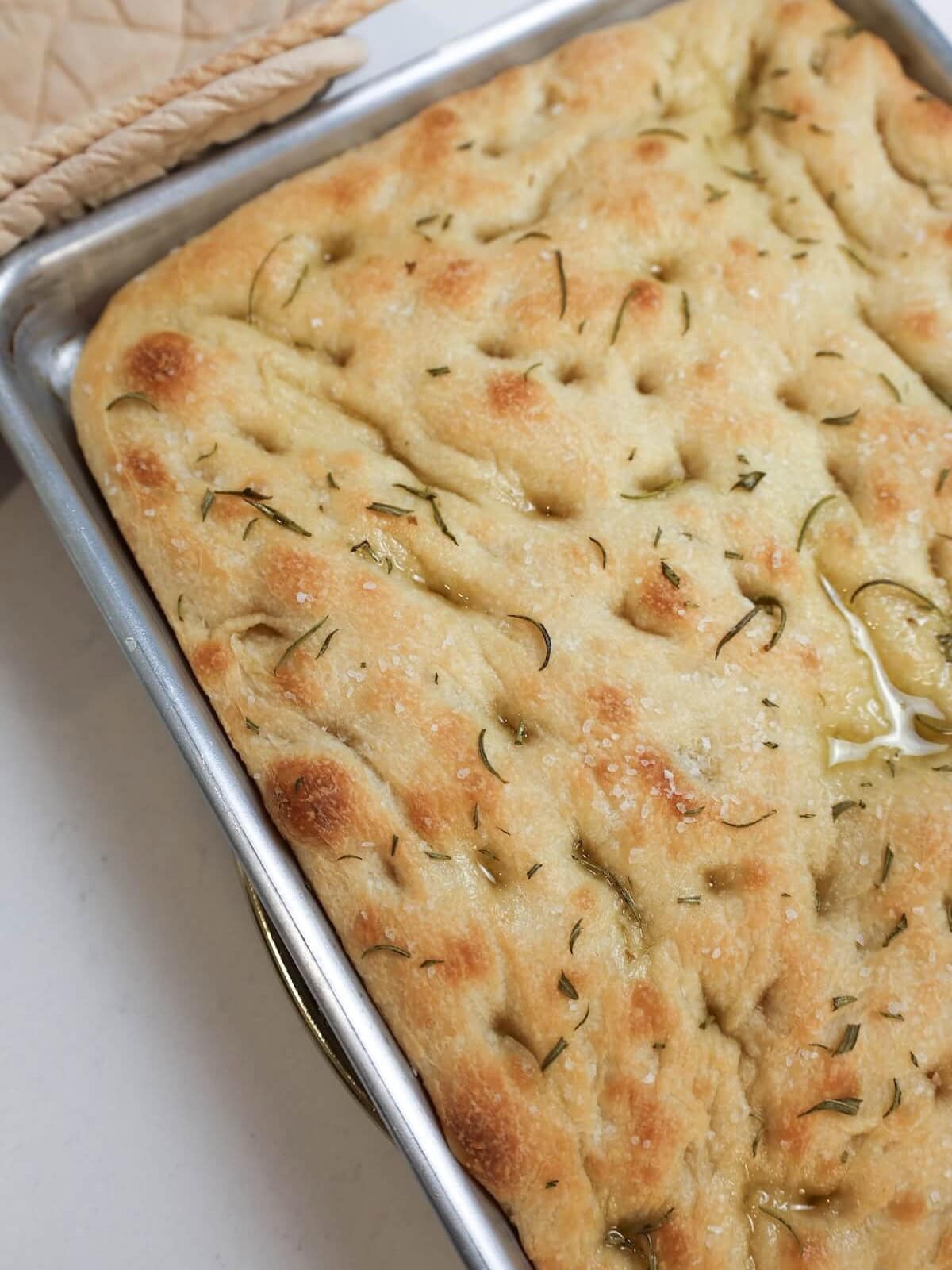 baked focaccia in a pan.