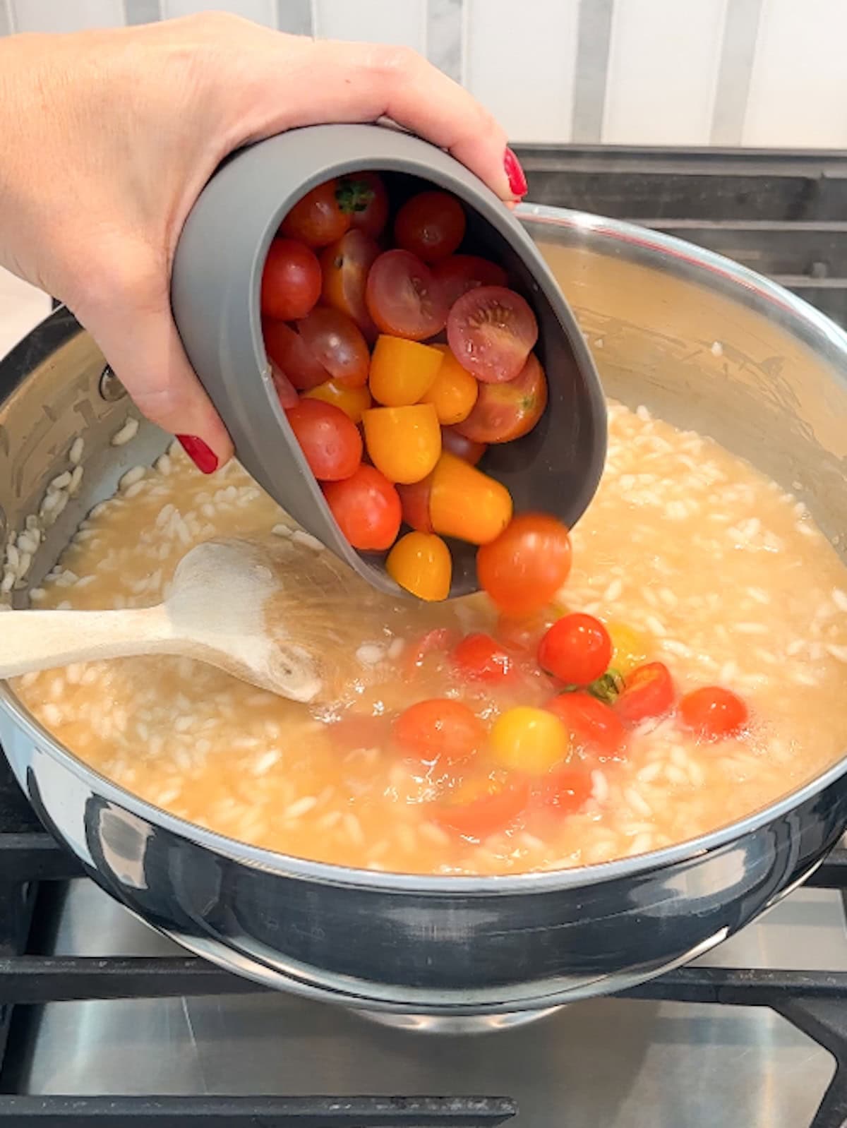 Add cherry tomatoes to risotto after the last addition of broth.